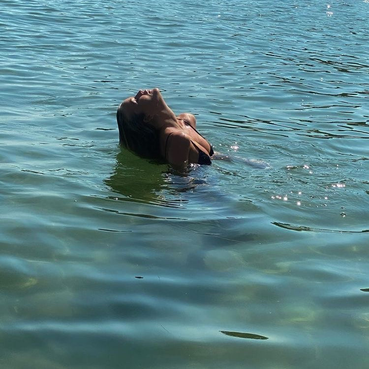 Women swimming in the French Riviera, in tropical blue waters with her BeachedWashed, modern mermaid hair
