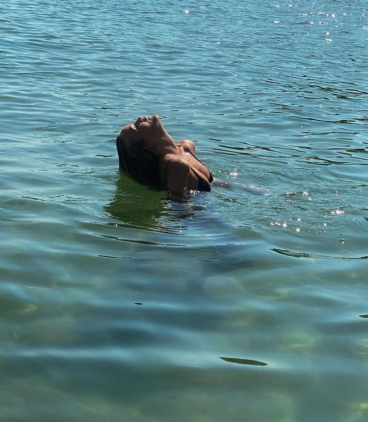 Women swimming in the French Riviera, in tropical blue waters with her BeachedWashed, modern mermaid hair